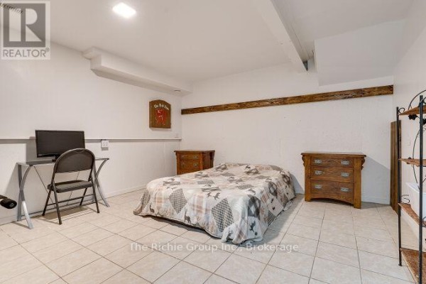 Bedroom with bed, desk, and wooden dressers - 624 Cedar Street W Shelburne