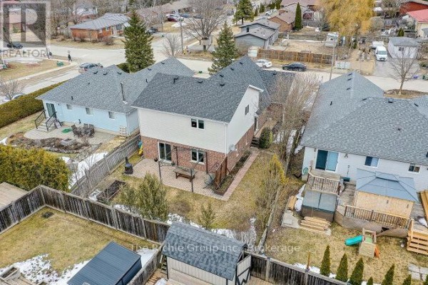 Backyard with hot tub, deck, patio, play structure & shed - 624 Cedar Street W Shelburne