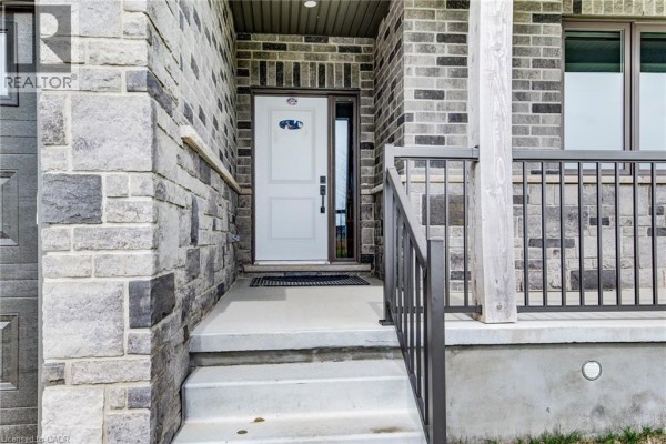 Steps leading up to the white front door and covered porch. - 625 Winchester Avenue S, Listowel