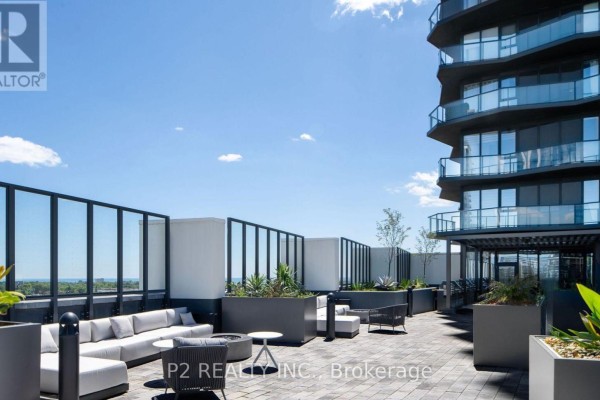 Outdoor patio with lounge furniture and planters overlooking the city. - 627 - 36 Zorra Street, Toronto