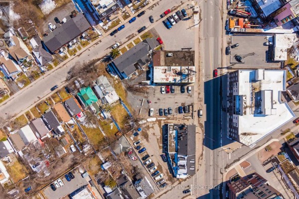 Aerial view of a city block showing multiple buildings, streets, and parked cars. - 627 Princess Street, Kingston