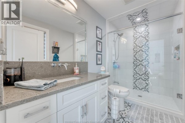 Finished basement with recessed lighting, laminate floors, and white doors - 6275 Disputed Rd. Lasalle