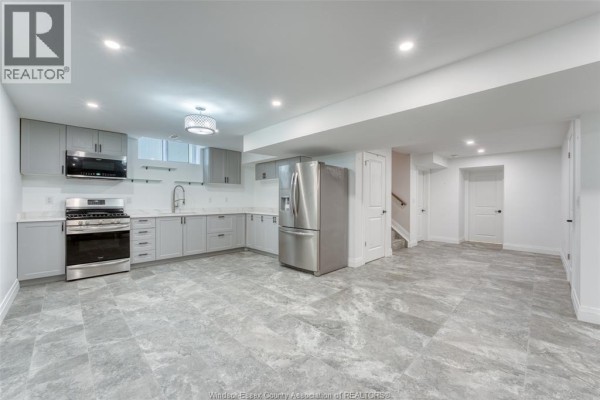 Gray leather sofas and a blue accent wall with mounted TV - 6275 Disputed Rd. Lasalle