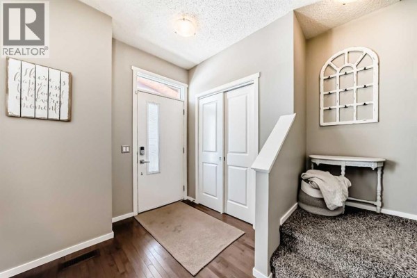 Kitchen featuring dark wood cabinets, stainless steel appliances, and open layout - 63 Chapalina Square Se, Calgary