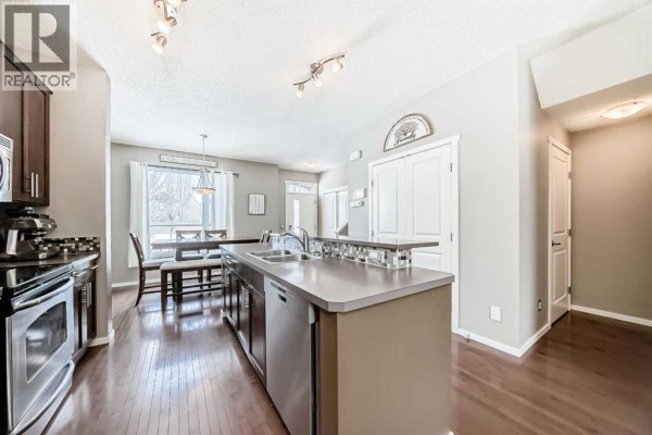 Exterior view of townhouse row with snow, showcasing architectural details - 63 Chapalina Square Se, Calgary