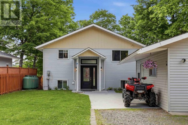 Front exterior of a two-story house with light blue siding, a covered entryway, and an attached garage. - 63 Heyden Lake Rd, Aweres
