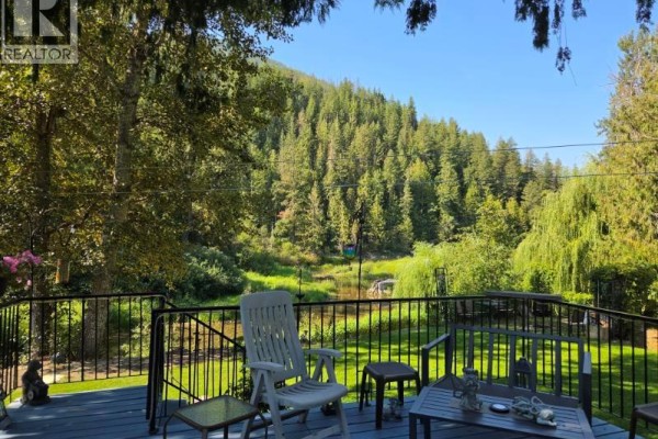 Scenic view of river surrounded by trees and mountains - 630 Enderby Mabel Lake Road, Enderby