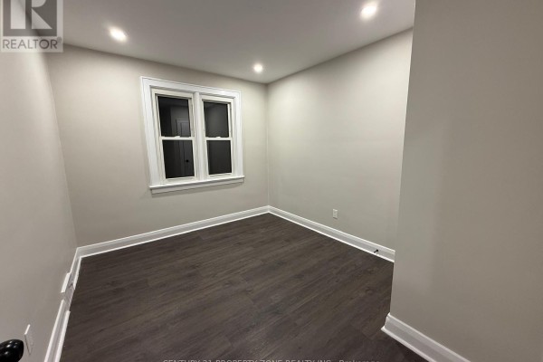 Small room with light grey walls, dark wood-look flooring, and a single window. - 6300 Corwin Crescent, Niagara Falls