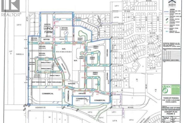 Aerial view of undeveloped land adjacent to existing homes and distant town buildings, with one section highlighted in purple. - 6302 48 Avenue, Ponoka