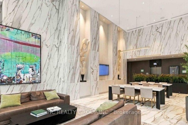 Lobby lounge area with marble walls, modern art, and seating. - 6305 - 448 Burnhamthorpe Road, Mississauga