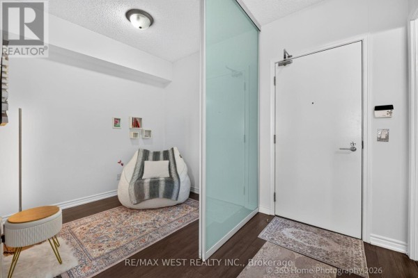 Apartment entryway with white walls, dark wood floor, and a frosted glass partition. - 631 - 15 James Findlay Way, Toronto