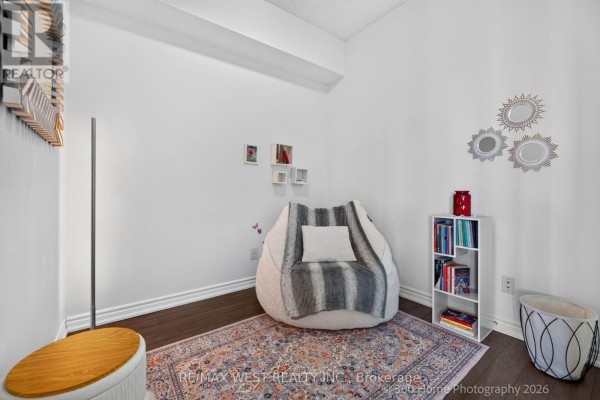 Cozy corner with a large floor cushion, blanket, small bookshelf, and decorative wall art. - 631 - 15 James Findlay Way, Toronto