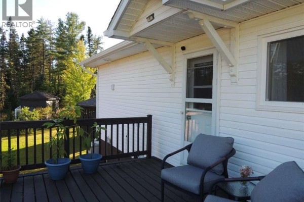 Close-up of deck with chairs overlooking a treed yard and entrance to the home. - 631 Gloucester Junction Road, Gloucester Junction