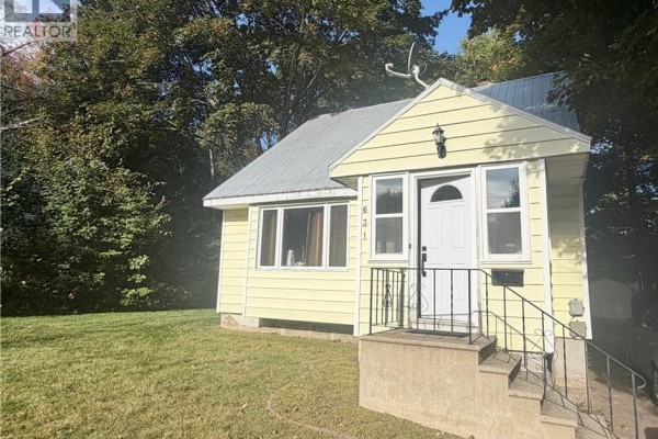 Close-up of the front entrance of a yellow house with a white door and windows. - 631 Mitchell Street, Fredericton