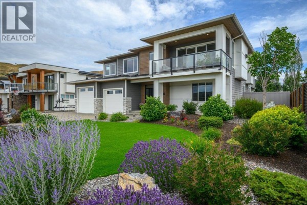 Backyard patio with a swimming pool, slide, gas fire pit, and outdoor seating area. - 631 Mt Ida Crescent, Coldstream