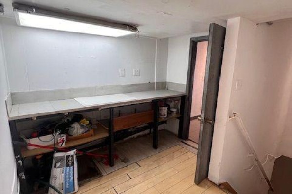 View of a commercial space's interior towards the street-facing window and entrance. - 632 Bloor Street W, Toronto