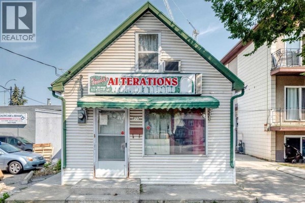 Front exterior of the 'Linda's Alterations' building, showing the main entrance and display window with clothing. - 632 Marsh Road Ne, Calgary