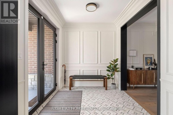 Foyer with a bench, umbrella stand, potted plant, and decorative console table. - 6326 Old Garrison Boulevard, London South