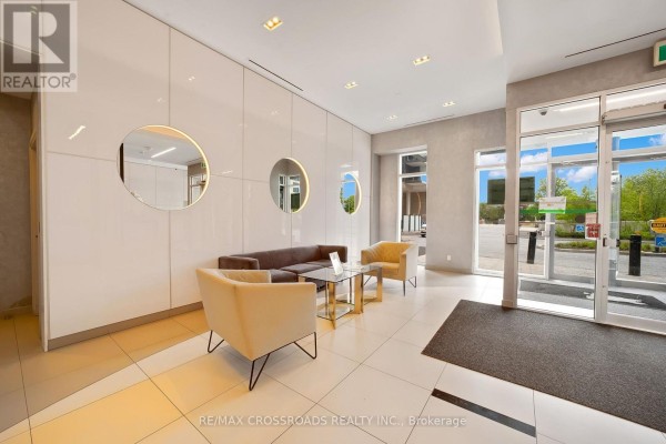 Building lobby with white paneled walls, modern furniture, and tile flooring. - 633 - 20 Meadowglen Place, Toronto