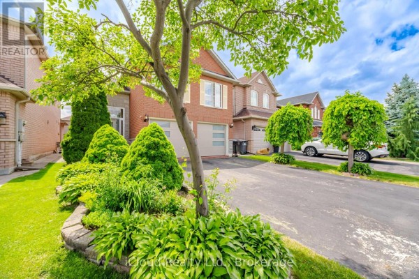 Side view of the house showing landscaping, driveway, and neighboring properties. - 6332 Glen Meadows Road, Mississauga