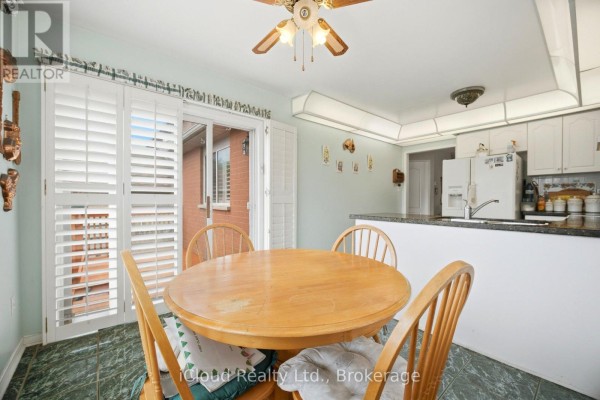 Dining area with round table, chairs, and plantation shutters - 6332 Glen Meadows Road Mississauga