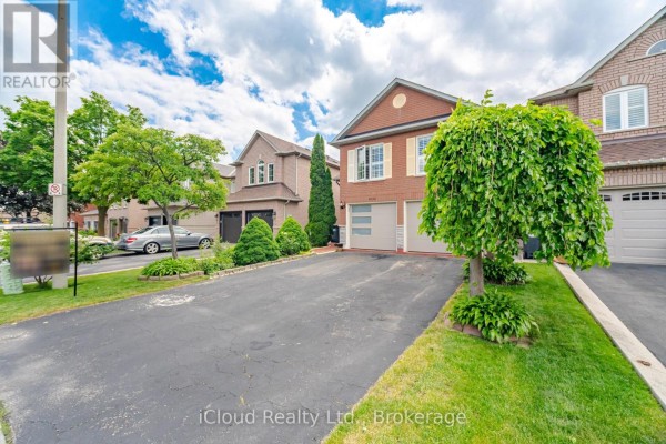 View from the driveway towards the house, with green lawn and trees. - 6332 Glen Meadows Road, Mississauga