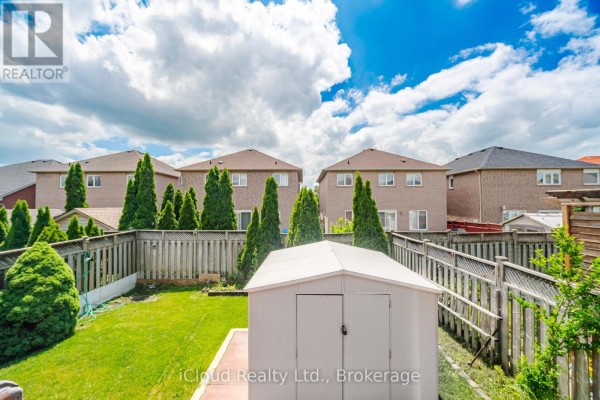 Backyard with storage shed, green lawn, and trees - 6332 Glen Meadows Road Mississauga