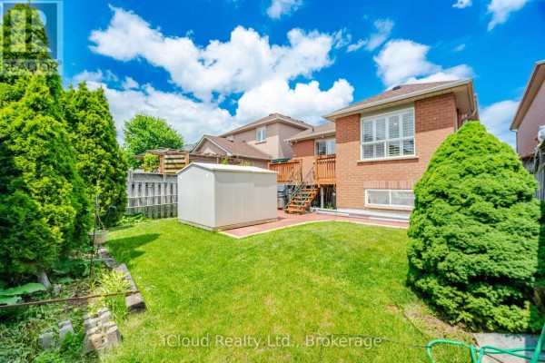Backyard with storage shed, wooden deck, and green lawn - 6332 Glen Meadows Road Mississauga