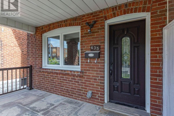 Detailed view of the dark front door of the house at 635 Glenholme Avenue, with a window and mailbox. - 635 Glenholme Avenue, Toronto