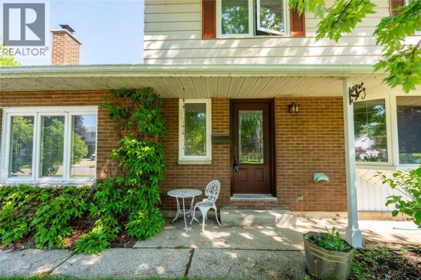 Close-up of the front entrance with a small table and decorative wreath - 635 Highbury Park, Sarnia