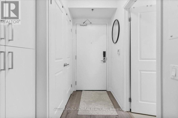 Bright entryway with white walls, closet space, and a decorative rug - 636 - 1900 Simcoe Street N, Oshawa