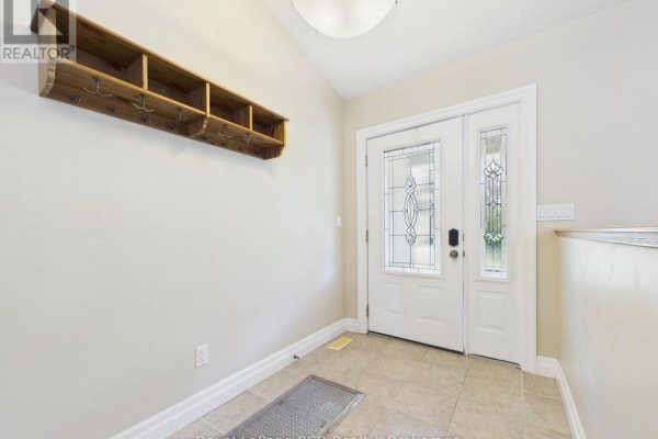 Interior entryway with a tiled floor, white door, and wooden shelf. - 636 Kairshea Avenue, Huron Kinloss