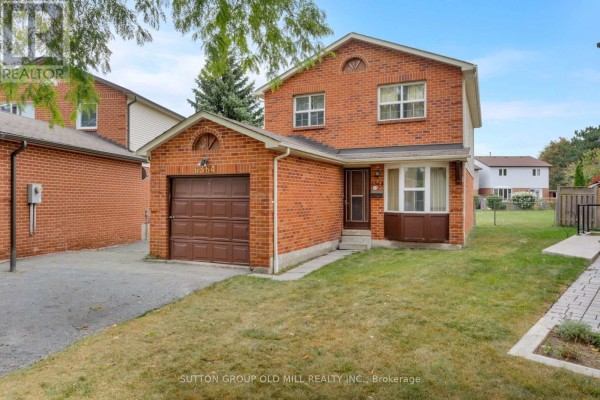 View of the red brick house exterior with a driveway and grass. - 6364 Plowmans Heath, Mississauga