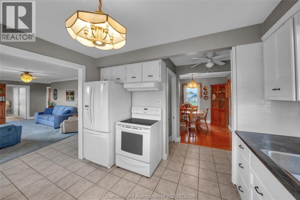 Sunroom with wooden ceiling, large windows, and a patterned sofa. - 637 Wilkesport Line, Sombra