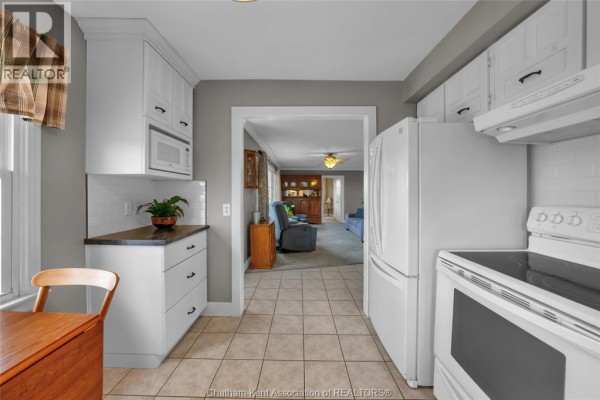 Finished basement living area with leather sofa, TV, and neutral-colored walls. - 637 Wilkesport Line, Sombra