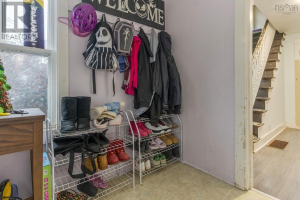 Mudroom with shoe rack, coats, helmet, and view of stairs. - 639 Faculty Drive, Greenwood