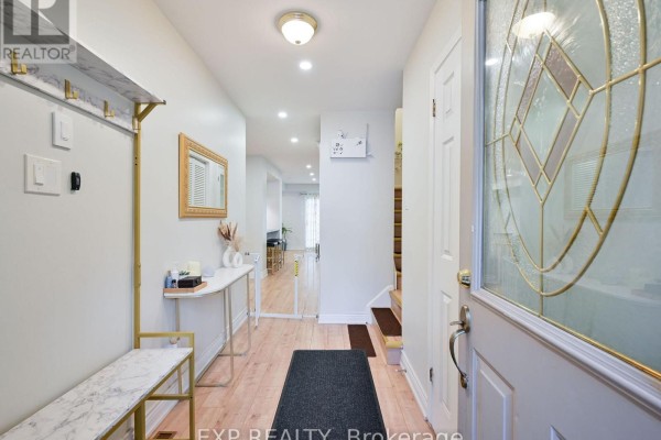Interior entryway with a white bench, console table, mirror, and a glass-paneled front door. - 64 - 3351 Hornbeam Crescent N, Mississauga