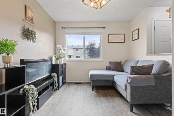 Aerial view of a townhouse complex with parking and green space. - #64 3221 119 St Nw, Edmonton