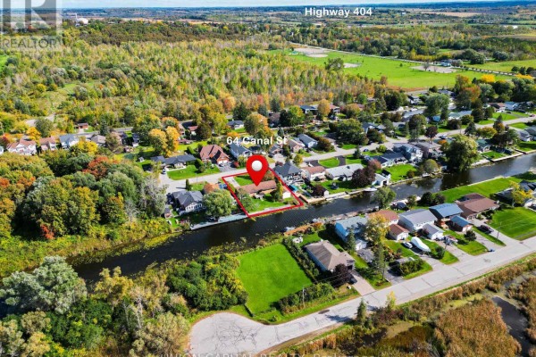 Aerial view of 64 Canal Street, showing the property's waterfront location on a canal. - 64 Canal Street, Georgina