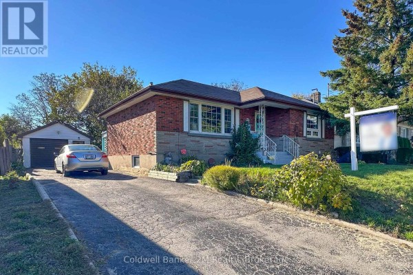 Side view of a brick bungalow with a detached garage and silver car on driveway. - 64 Harris Avenue, Oshawa