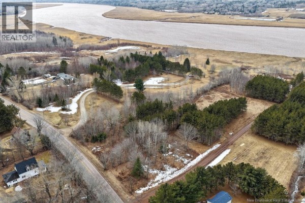 Wide aerial view showing a vast landscape with trees, fields, a river, and some houses below. - Lot 26-02 Dover Road, Dieppe