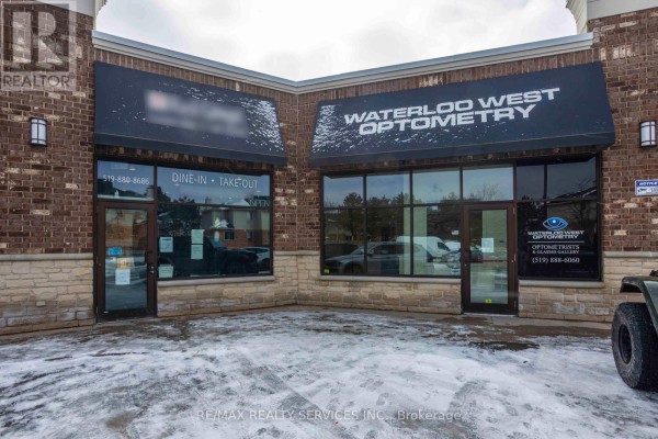 Exterior view of 'Waterloo West Optometry' with large windows and 'Dine-In Take-Out' signage. - 646 Erb St Street W, Waterloo