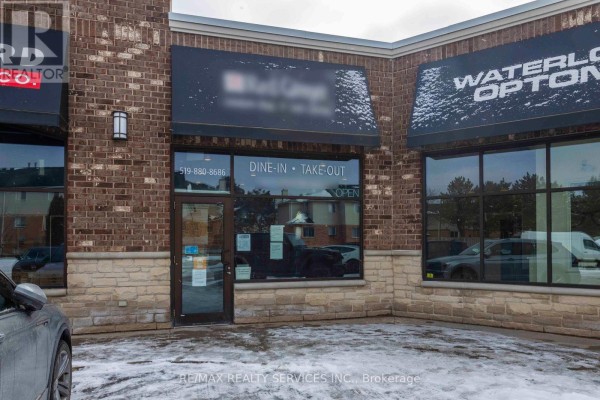 Close-up of 'Dine-In Take-Out' entrance with visible contact number and snow-covered ground. - 646 Erb St Street W, Waterloo