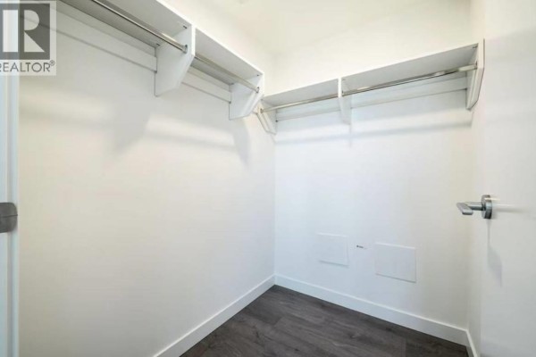 Contemporary bathroom with a walk-in shower, vanity, and marble tile walls. - 6468 Willingdon Avenue, Burnaby
