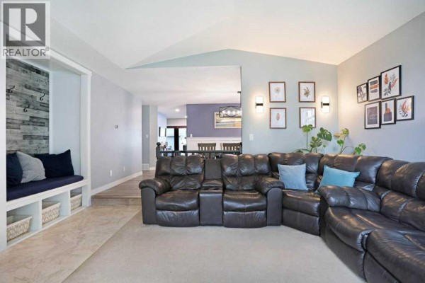 Interior view showing a living room sectional, bench seating, and entryway detail. - 648 2nd Street E, Brooks