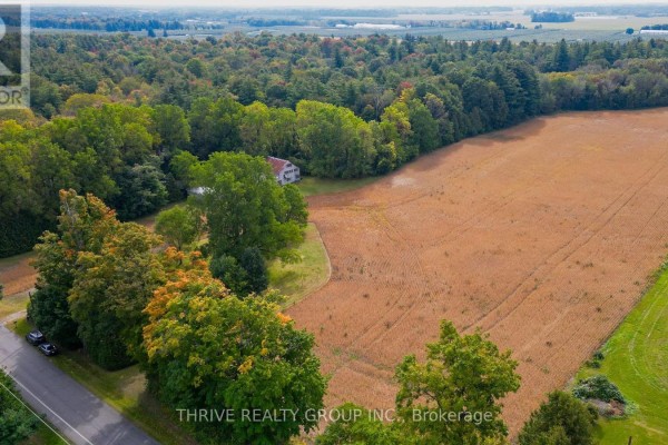 Aerial view of a yellow house surrounded by mature trees and foliage. - 648 Concession 13 Concession, Norfolk