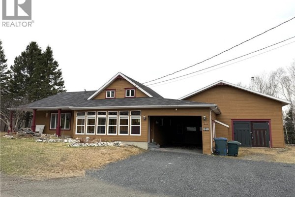 Wooden deck with sliding glass doors and snow-covered surroundings - 648 Toussaint Road, Saint Joseph