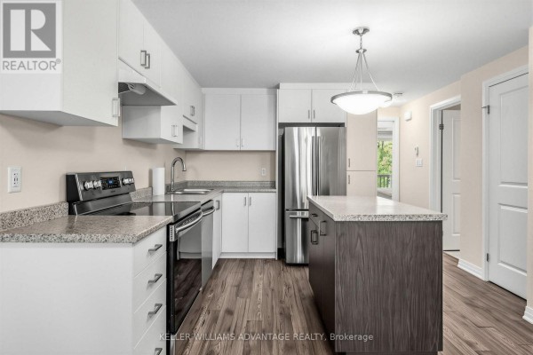 Kitchen with white cabinets, granite countertops, stainless steel appliances, and wood-look flooring. - 64a - 1989 Ottawa Street S, Kitchener