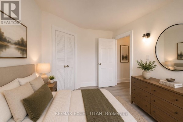 Kitchen with white cabinets, sink, stove, refrigerator, and light grey flooring. - 65 - 12 Kingston Road, Toronto