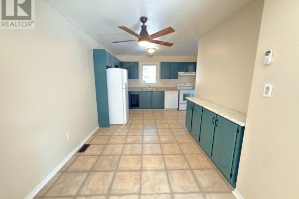 View down a hallway with light wood laminate flooring and beige walls. - 65 - 511 Admiral Drive W, London East